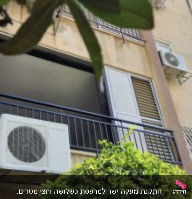 מסגרת חלון עם תריסים פתוחים ומזגן חיצוני